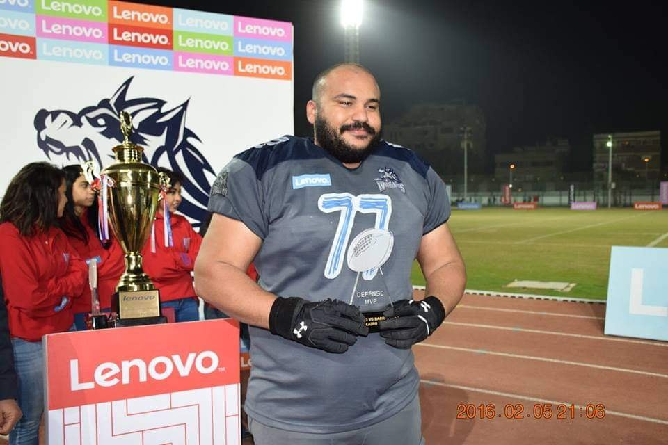 Ahmad in his Cairo Wolves number 77 jersey holding the defensive MVP award after the Amman Barracudas game, 5 February 2016