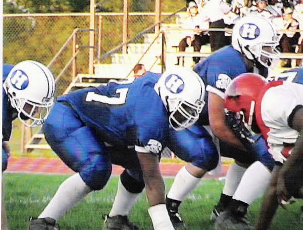 Ahmad in a three-point stance on the Hilliard Davidson line